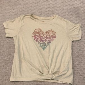 Cream Based. Multi Colored butterfly’s in heart shape.